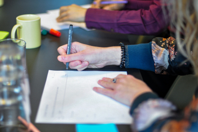 gruppe mennesker der sidder rundt om bord og skriver